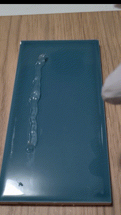 Spraying glass cleaner on a silicone bead completely dissolved by WipeOut reveals a clean surface free of residue.